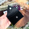 Handmade black suede card holder with blue labradorite gemstone and silver details by Siga Tribal.