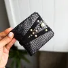 Handmade ORIN leather wallet with snake-embossed texture and antique gold studs