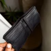 Handmade ORIN leather wallet with snake-embossed texture and antique gold studs