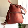Artisan leather talisman bag with fringe and metal details