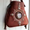 Artisan leather talisman bag with fringe and metal details